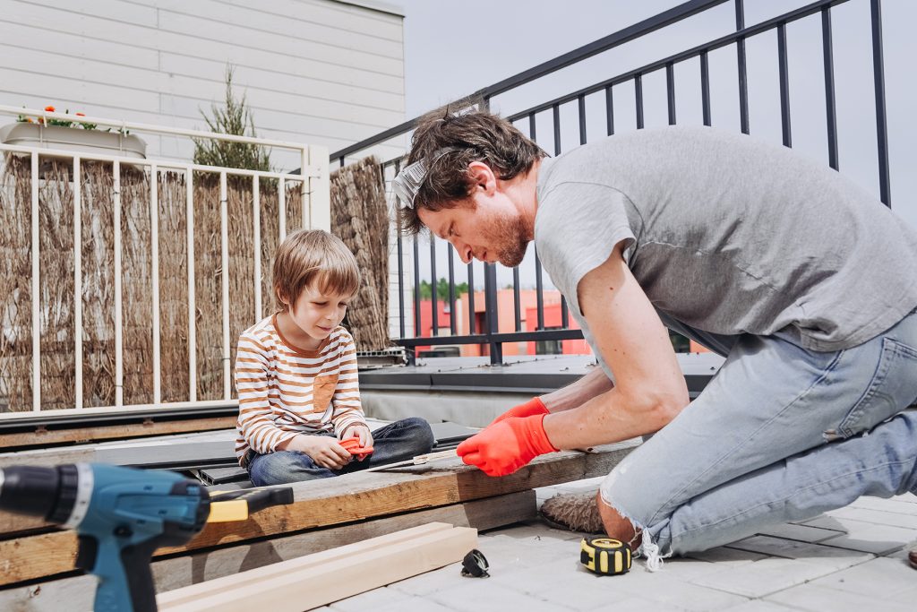 dad and son make a wooden toy out of plywood on th 2023 11 27 05 01 26 utc