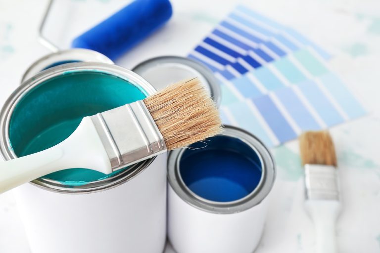 cans,of,paint,with,brush,on,table,,closeup